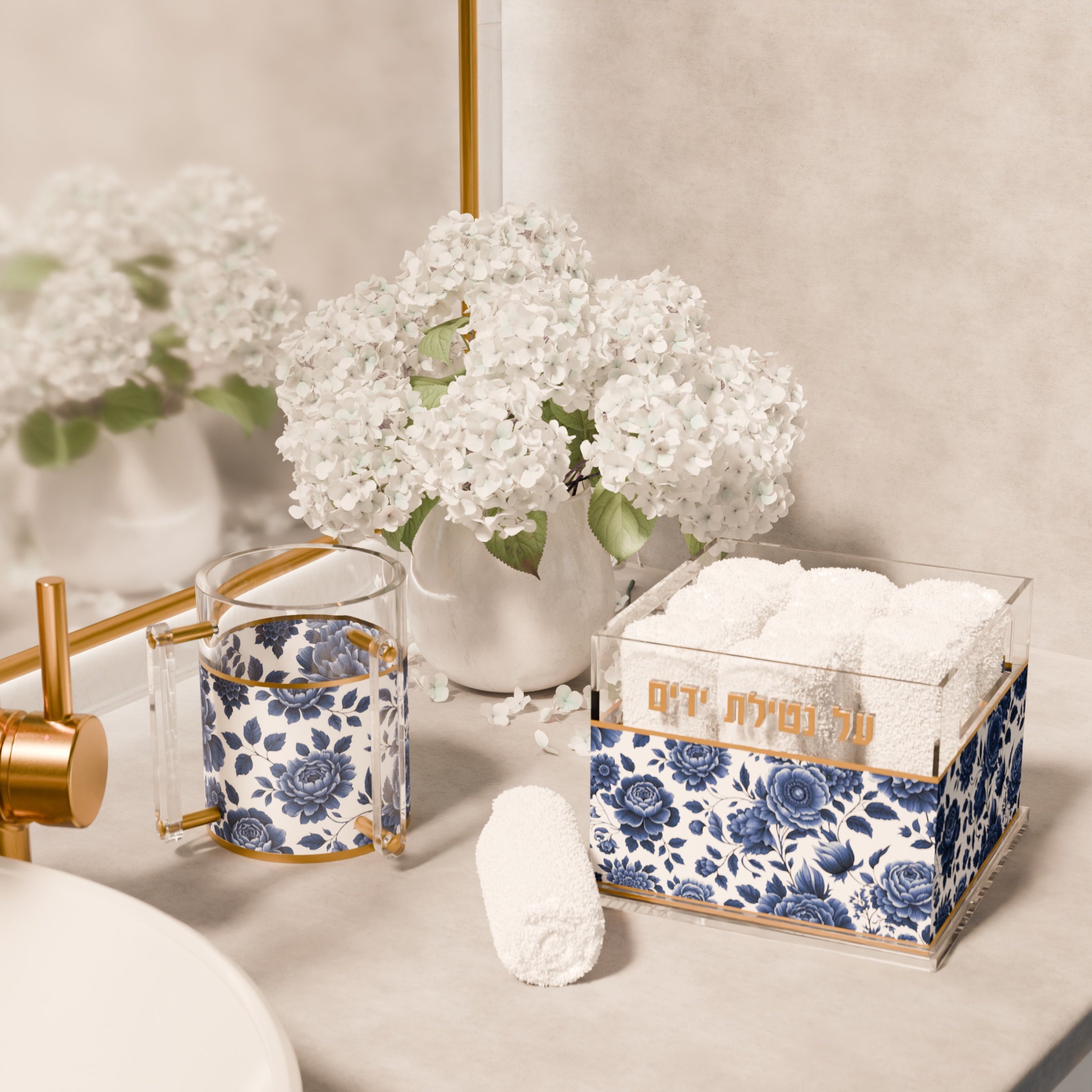 Maison Bloom washing cup and towel box in blue and white floral lucite on a washstand with white hydrangeas